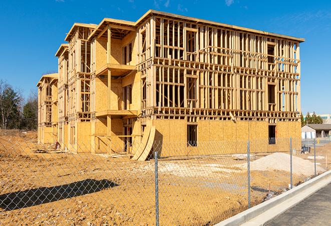 a close-up of temporary chain link fences enclosing a job site, signaling progress in the project's development in Glendora